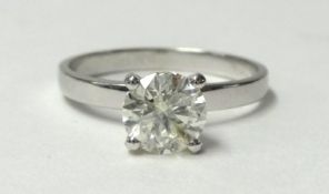 A white metal and single stone diamond ring, claw set with a brilliant cut stone of approximately