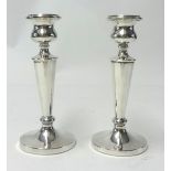 A pair of silver candle sticks of turned design.