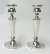 A pair of silver candle sticks of turned design.