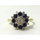 An 18ct sapphire and diamond cluster ring, size V.
