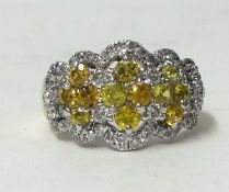 A yellow sapphire and diamond set ring, size N.