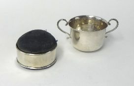 A silver twin handled porringer/sucre, weight 110g, also a silver circular pin cushion box (2).