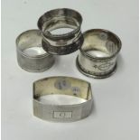 Four various silver napkin rings, weight 107g.