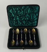 A set of six continental silver and enamelled tea/coffee spoons in fitted case, stamped 900. (6).