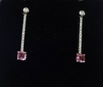 A pair of pink sapphire and diamond earrings.