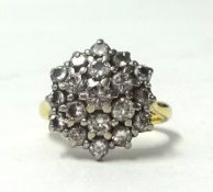 An 18ct gold diamond cluster ring, size M.