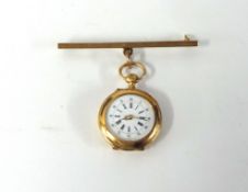 A small yellow metal open face fob watch with a 9ct gold bar.