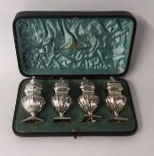 A set of four silver pepper pots, in original fitted case, James Usher, Lincoln, weight 6.15oz.