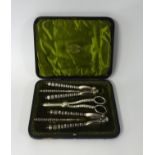 An Edwardian silver plated cased 5 piece nutcracker and grape scissor set in original fitted case,