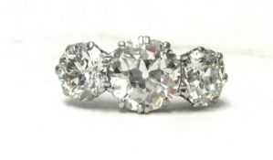 A stunning diamond three stone ring, of good clarity, total diamond weight approx. 4.50 carats, size