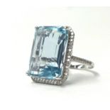 A 14k white gold and diamond ring set with an emerald cut aquamarine, approx. 15ct diamonds, approx.