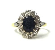 An 18ct sapphire and diamond cluster ring, size S.