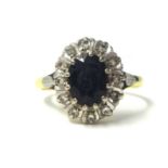 An 18ct sapphire and diamond cluster ring, size S.