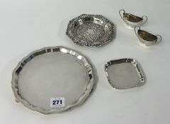 A silver circular waiter, a pair of silver table salts with half fluted bodies, a square pin dish