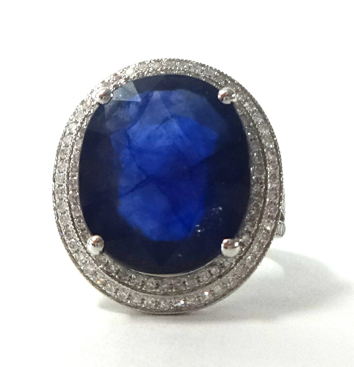 A 14k white gold and diamond ring set with an oval cut blue sapphire approx. 13 cts, the diamonds