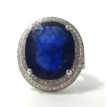 A 14k white gold and diamond ring set with an oval cut blue sapphire approx. 13 cts, the diamonds