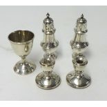 Silver egg cup, a pair of miniature silver candle holders and two silver salts.