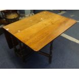 An Antique drop flap table with 18th Century oak base and later top