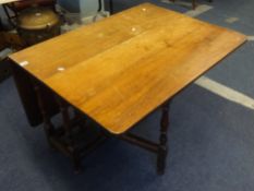 An Antique drop flap table with 18th Century oak base and later top