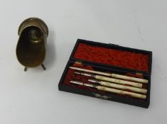 A four piece bone instrument set, cased. Also a Trench Art stand (2)