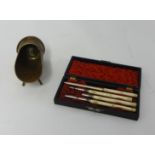 A four piece bone instrument set, cased. Also a Trench Art stand (2)