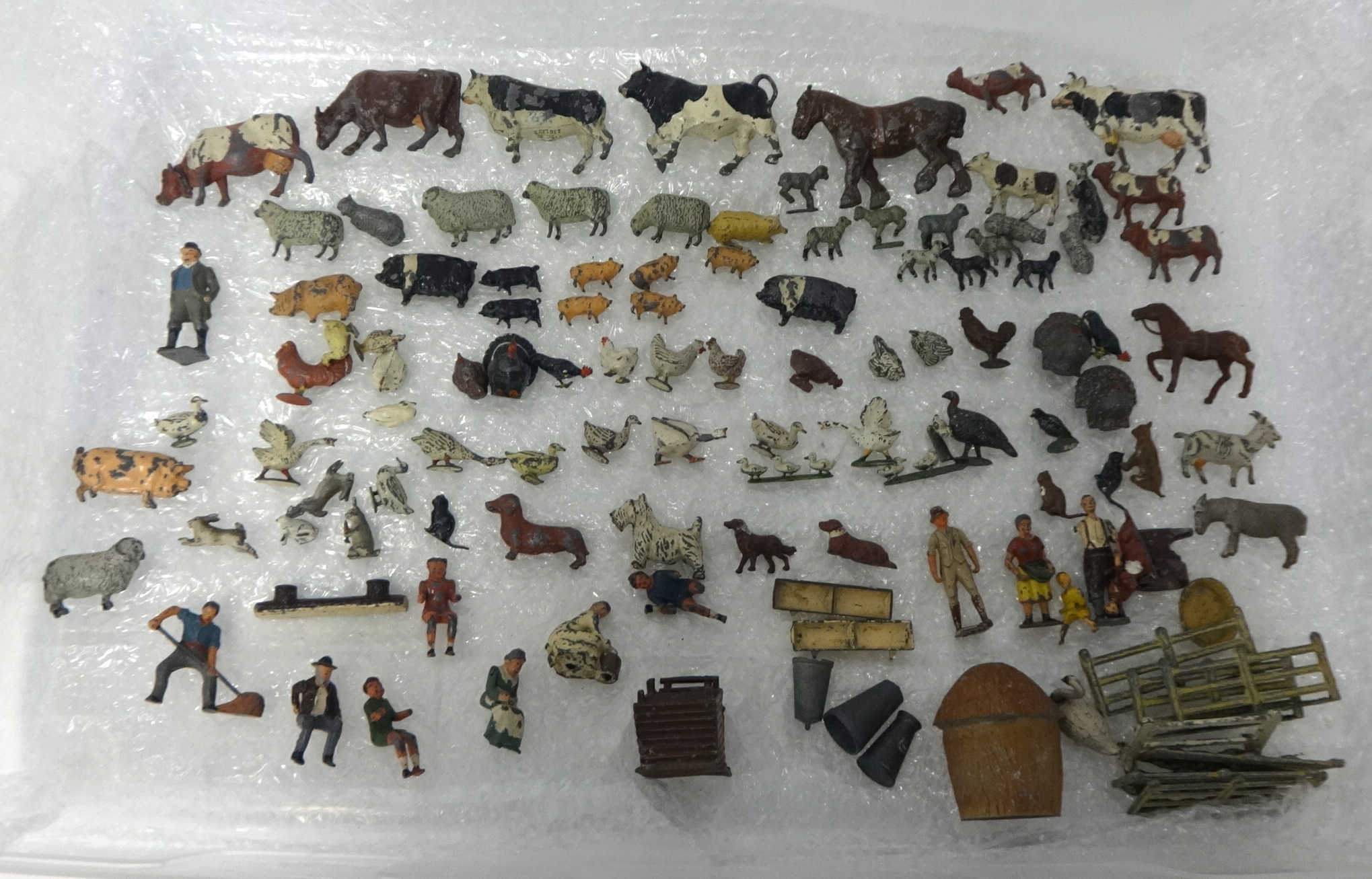 An antique collection of lead farmyard animals and figures.