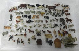 An antique collection of lead farmyard animals and figures.