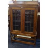 An oak two door bookcase with leaded glazed doors, width 82cm.