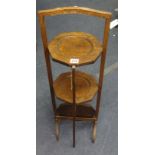 An oak three tier cake stand and a canteen cutlery box.