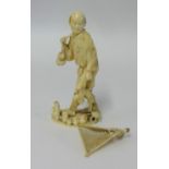 A carved ivory figure of a fisherman height 13cm