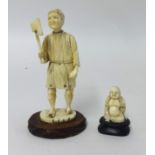 A carved ivory figure of an axeman and a small carved Buddha (2).