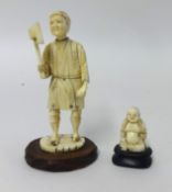 A carved ivory figure of an axeman and a small carved Buddha (2).