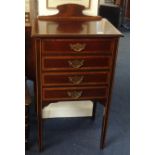 An Edwardian mahogany and inlaid music cabinet