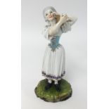 A 19th Century German porcelain figure of a women holding a vanity with blue cartwheel mark possibly