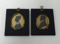 A pair of miniature silhouettes in original frames.