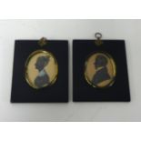 A pair of miniature silhouettes in original frames.