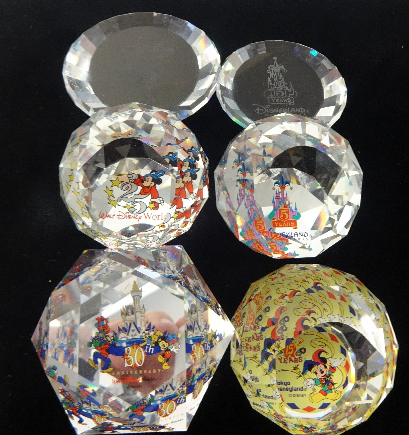 Swarovski Crystal glass Collection of paperweights. 4 Disney anniversary paperweights and 2