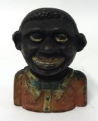 An antique cast iron 'The Young N*** Money Bank'.