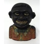 An antique cast iron 'The Young N*** Money Bank'.