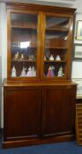 A Victorian mahogany bookcase, the upper section with two glazed doors over a base fitted with three
