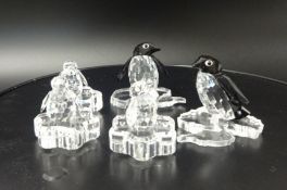 Swarovski Crystal glass Penguin family and 3 stands.