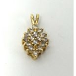 A modern diamond set gold pendant, stamped 14k.