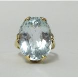 A large pale aqua marine single stone ring, set in a yellow metal shank, indistinctly hallmarked,