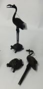 A pair of Japanese bronze storks, stood on a turtle, height 24cm.