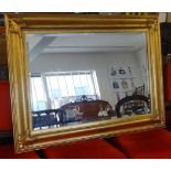 A modern gilt framed rectangular mirror