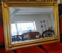 A modern gilt framed rectangular mirror