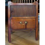 A Georgian mahogany tray top and tambour front bedside cabinet fitted with pull out lower drawer.