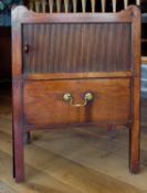 A Georgian mahogany tray top and tambour front bedside cabinet fitted with pull out lower drawer.