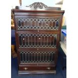 A mahogany three section Globe Wernicke style bookcase with leaded glazed doors and lower fitted