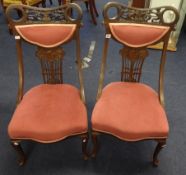 A pair of Edwardian carved wood nursing chairs.